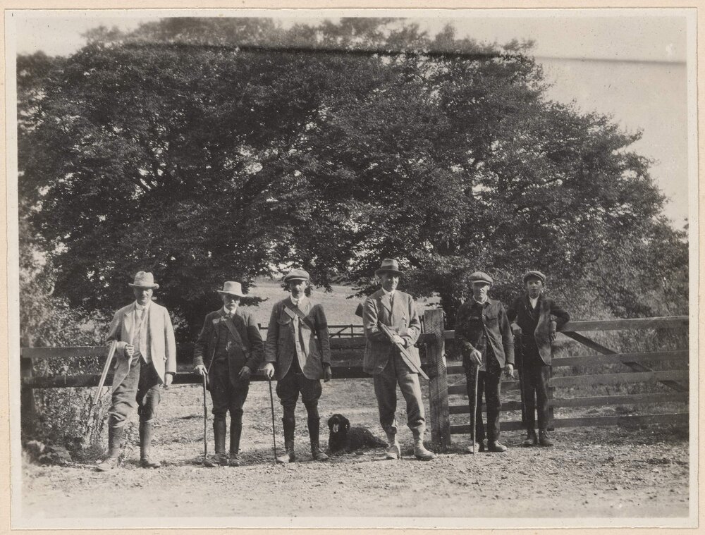 [Group photo of five men and one young man]