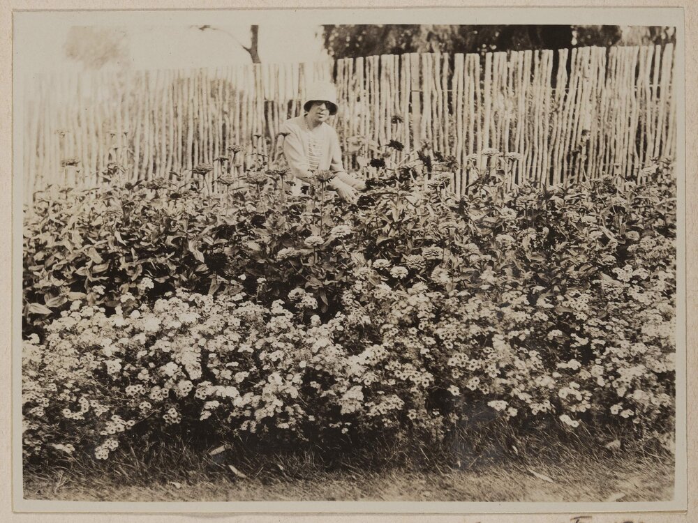 [Mabel tending flowers]