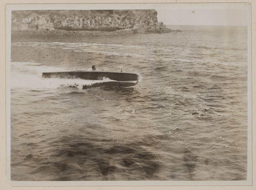 [Side view of driving motorboat]