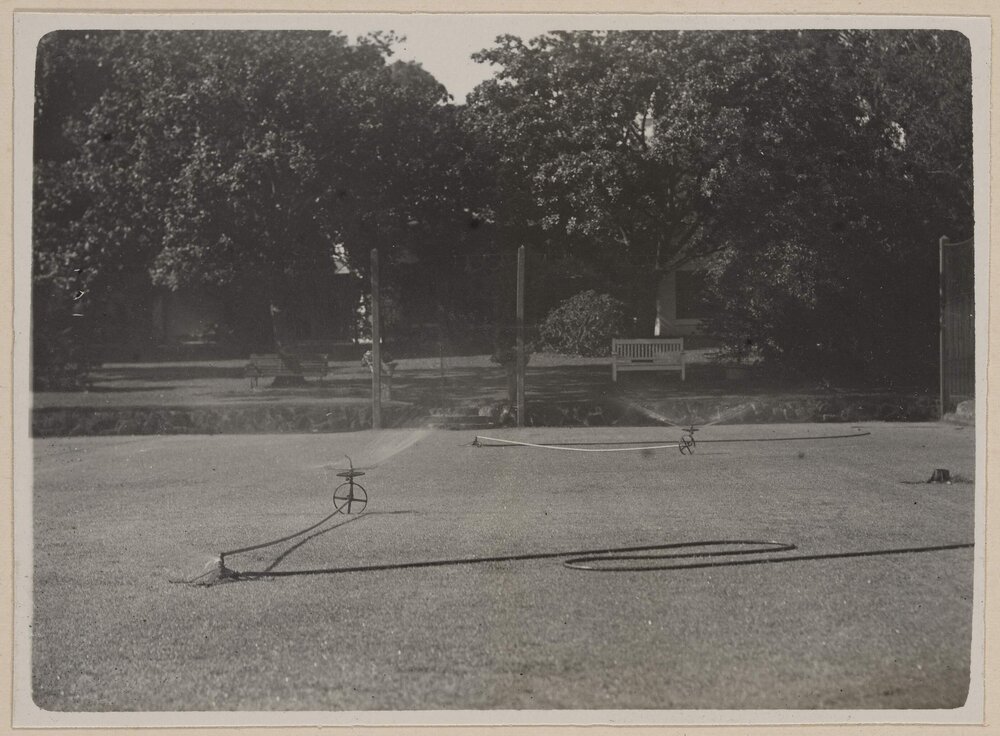 [Two sprinklers on lawn]