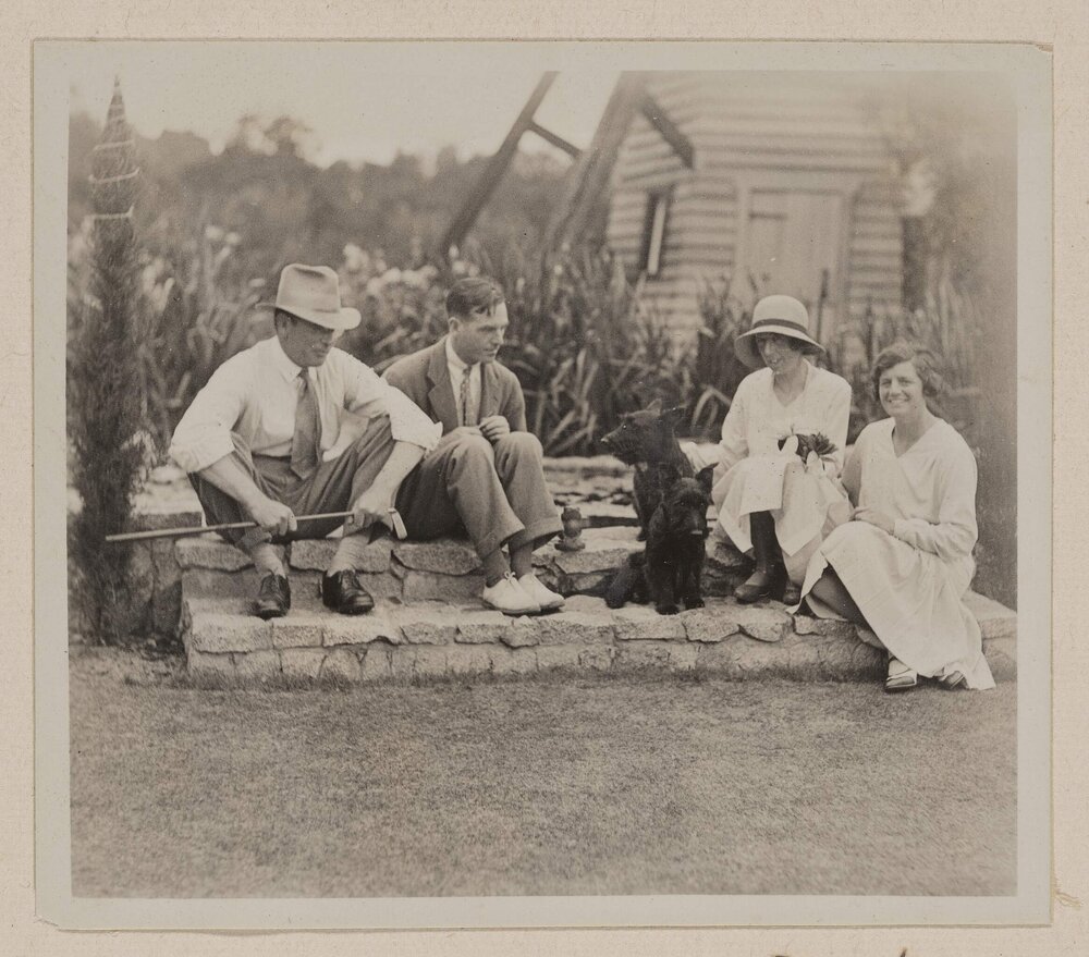 [Group seated on stone steps of lily pond] Westerfield Xmas 1930