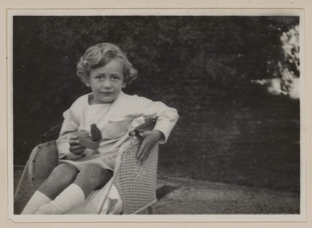 [Child holding bird figurine, Miegunyah]