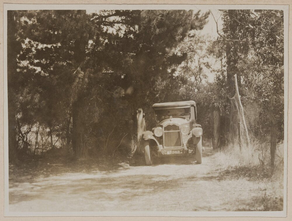 [Motor car on dirt road]