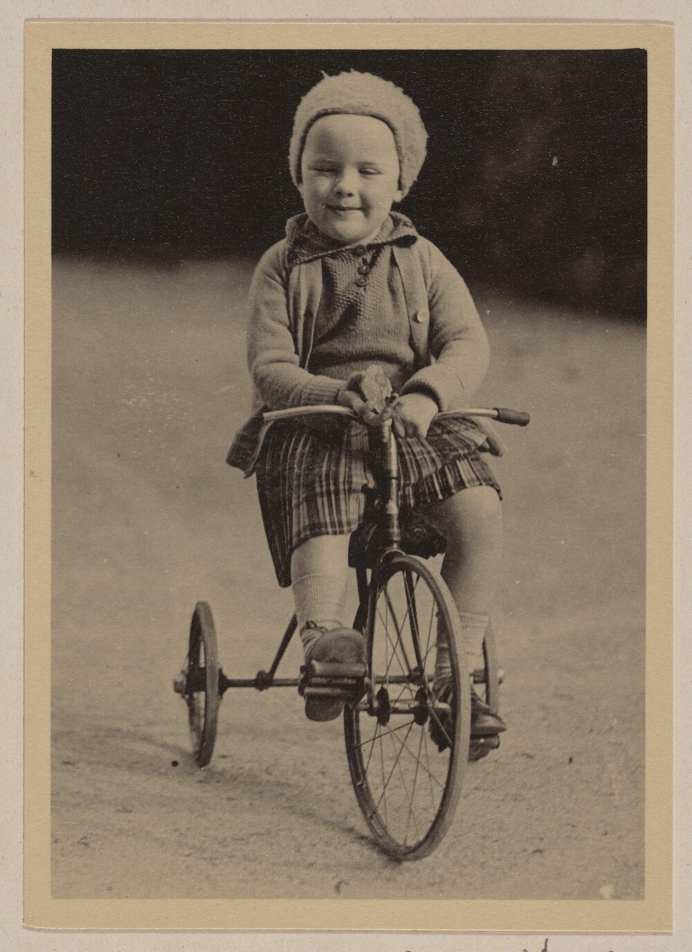[Small girl riding tricycle]