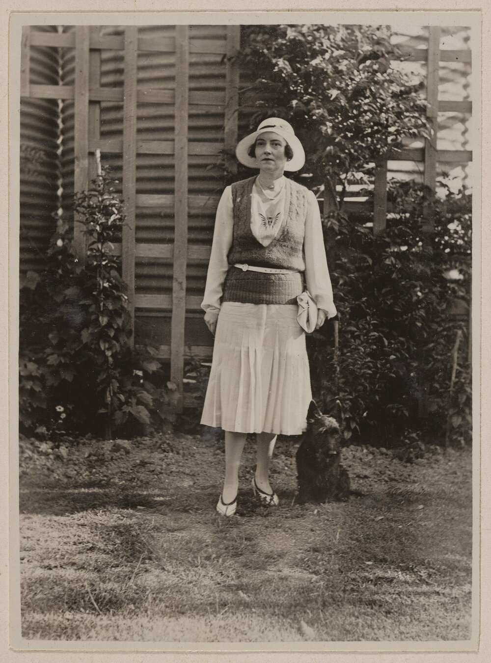 [Woman posed with Terrier dog]