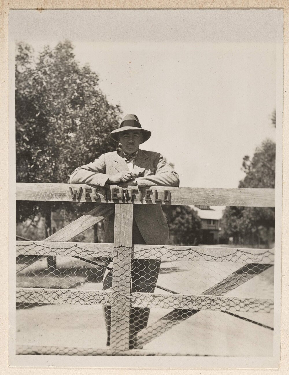 [Man leaning on gate at Westerfield]