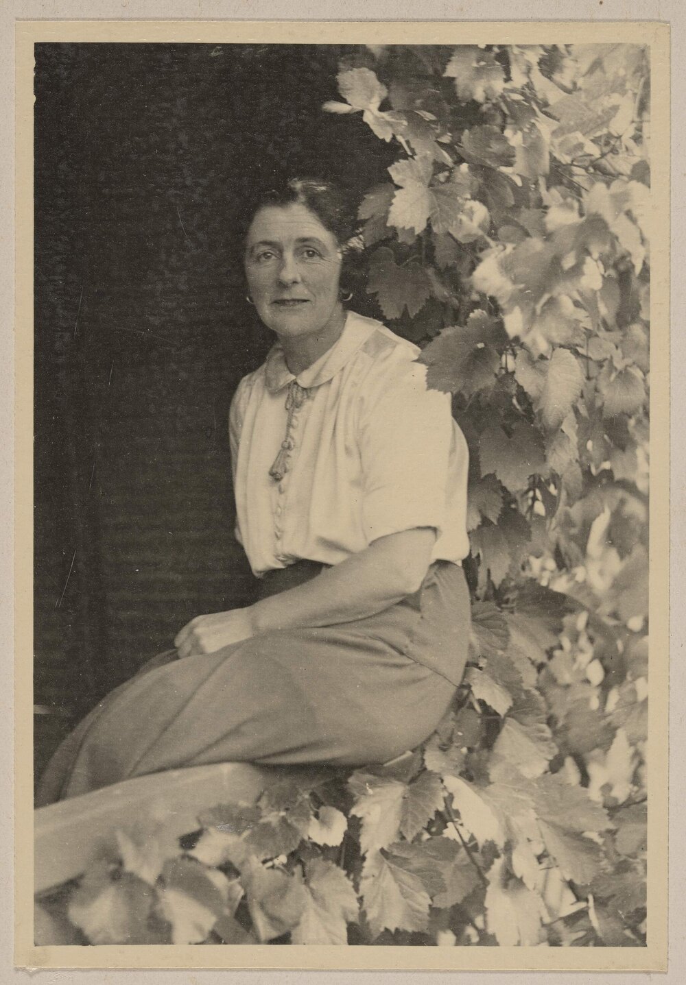[Woman in seated on veranda railing]