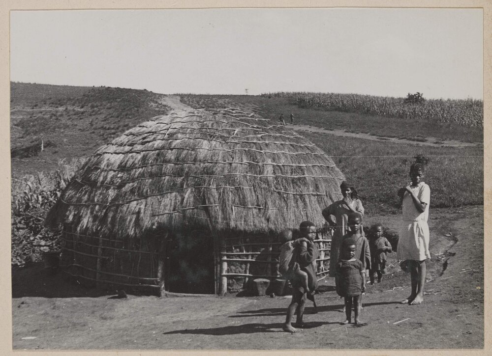 [Zulu family in front of their hut, the Valley of a Thousand Hills near Durban]