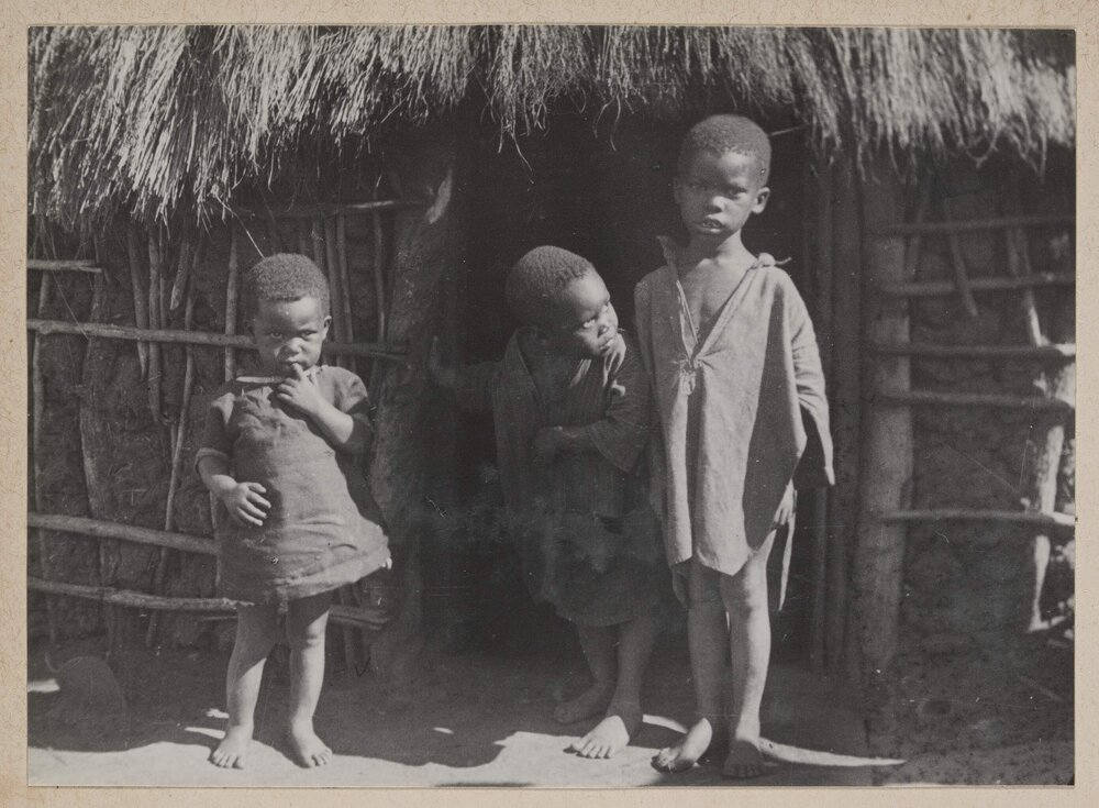 [Zulu children outside hut]