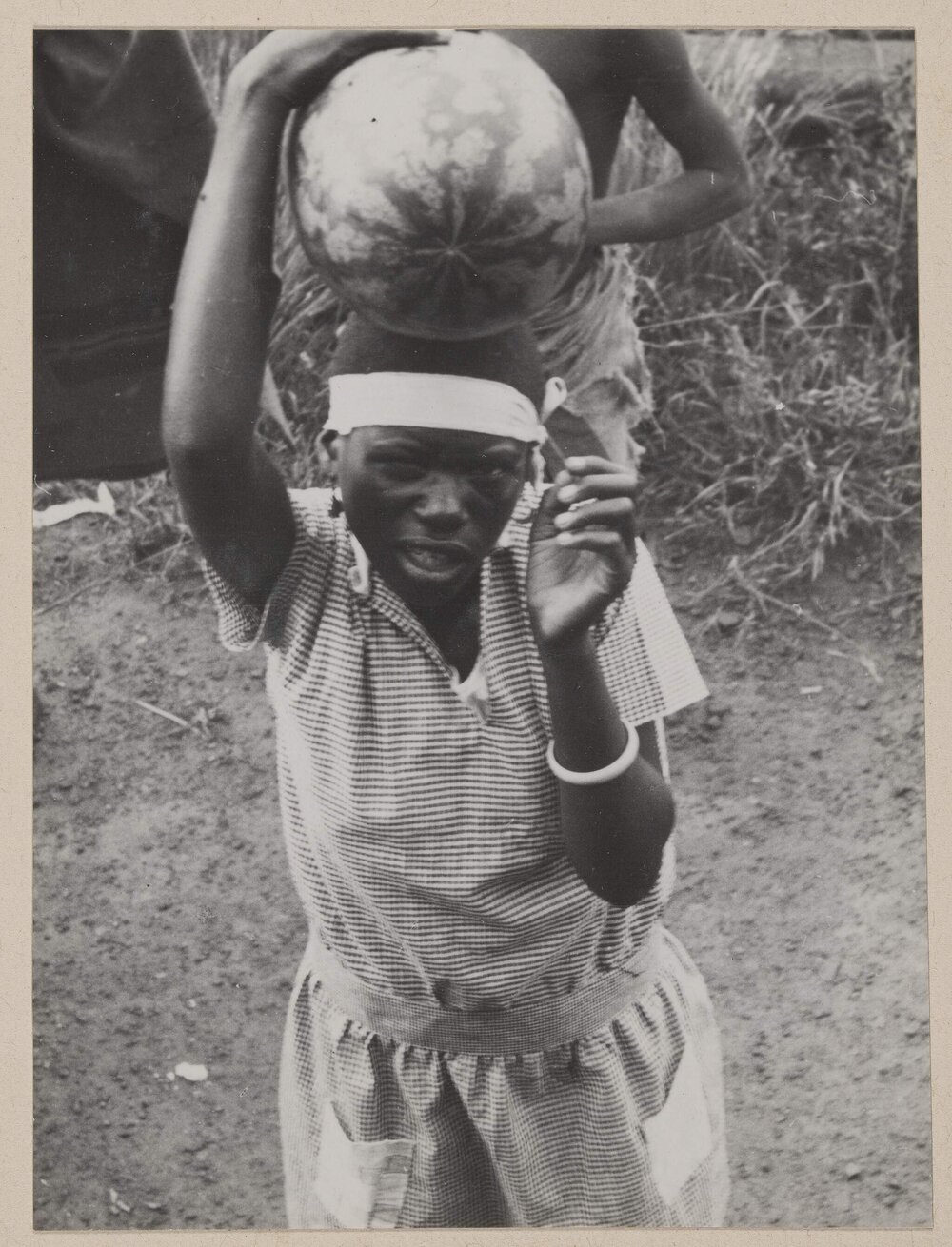 Bechuanaland native [boy carrying watermelon]