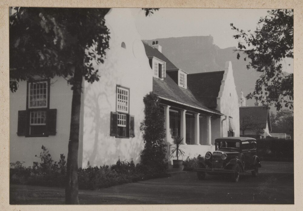 [Motor car parked outside building]