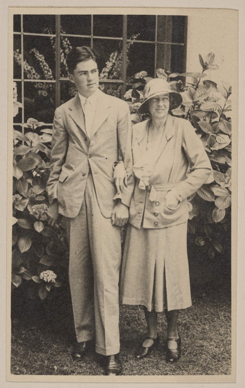 [Woman and young man posed in front of Hydrangea, Miegunyah]