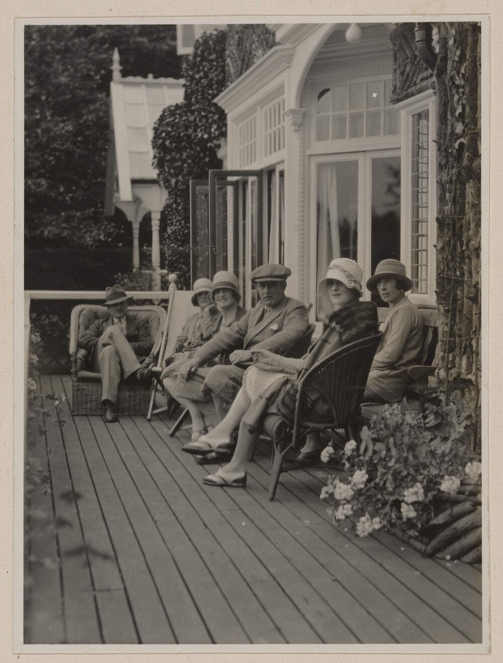 [Group photo posed on verandah]