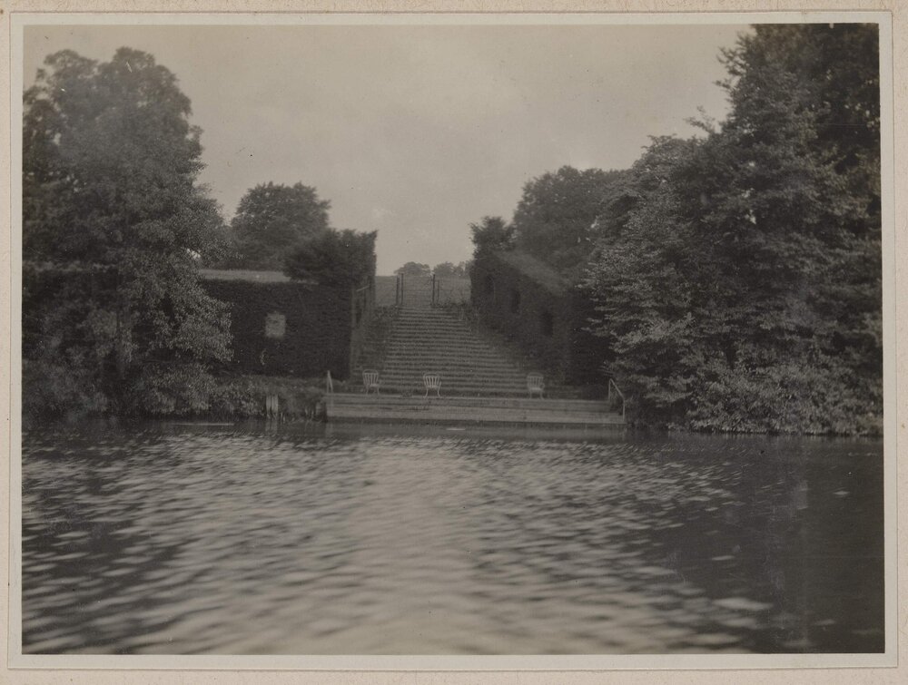 [River with steps ascending to fence]