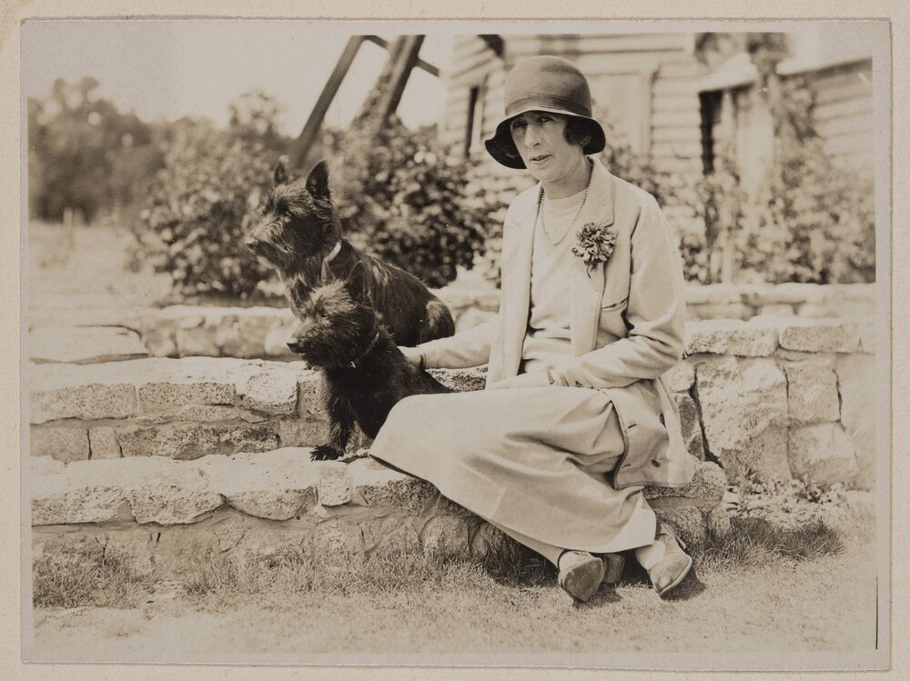 [Mabel seated with dogs on lily pond stone wall] Westerfield]