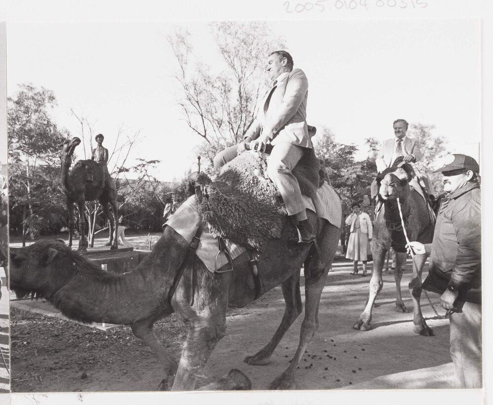 [Malcolm Fraser riding a camel in Alice Springs]