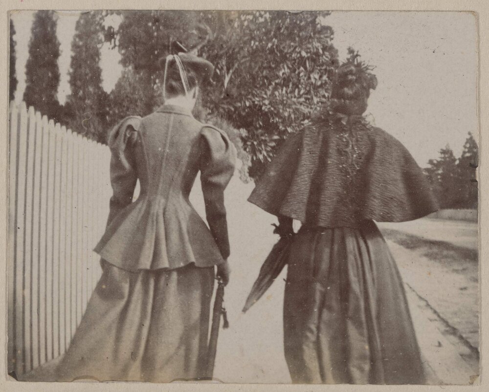 [Two women photographed from behind]