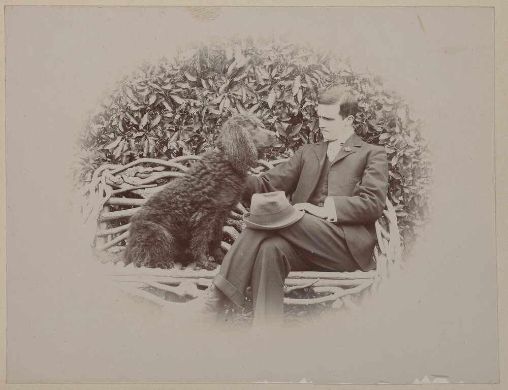 [Seated man with dog]
