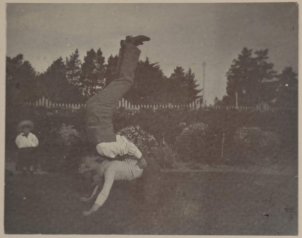 [Two men somersaulting over each other]