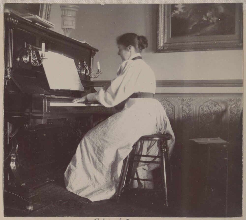 [Alice seated at piano