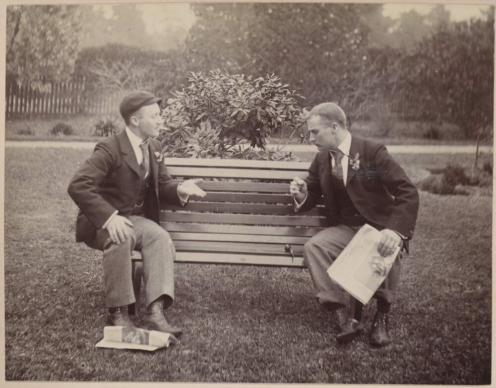 [Two men sitting on garden bench seat] 