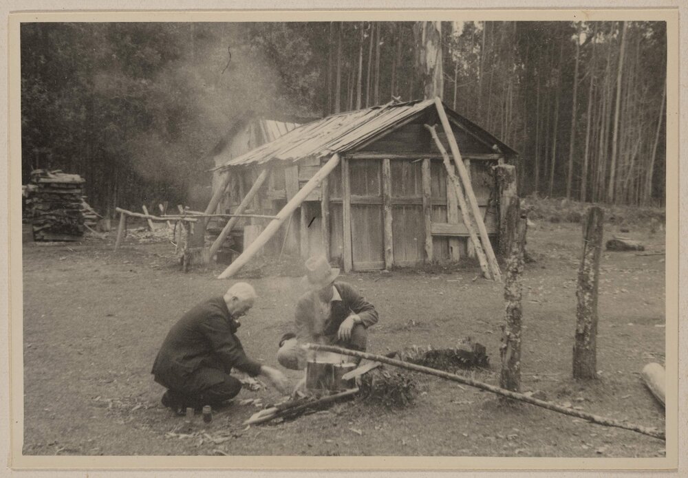 [Poet Laureate John Masefield tending camp fire Cumberland Valley, Victoria, Australia]