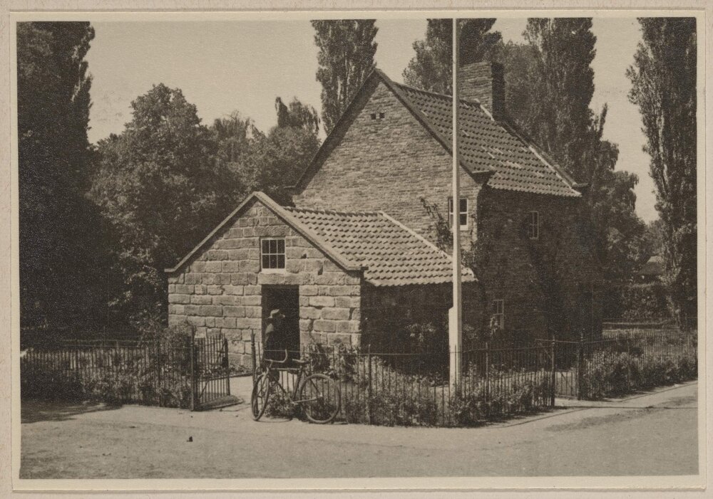 [External view of Cooks' Cottage, Fitzroy Gardens, Melbourne showing the iron entrance gate]