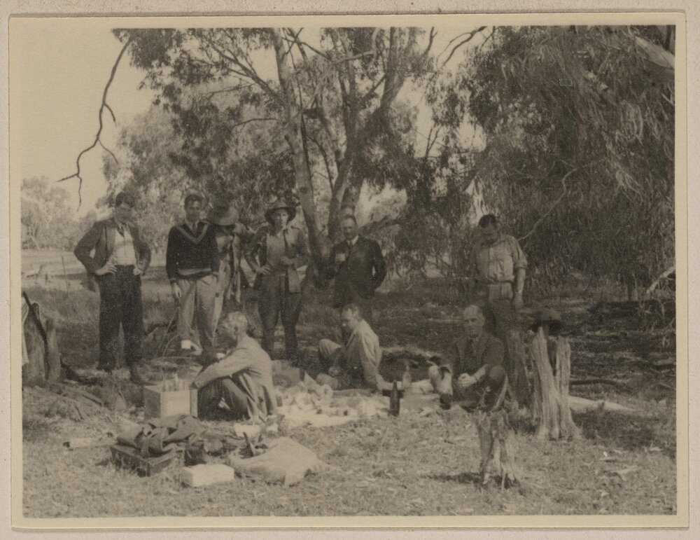 [Group of men gathered under tree at] Tupra
