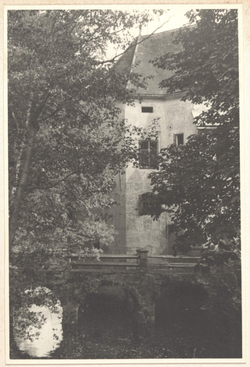 [Stone arch bridge over river , beside stone house, Austria]