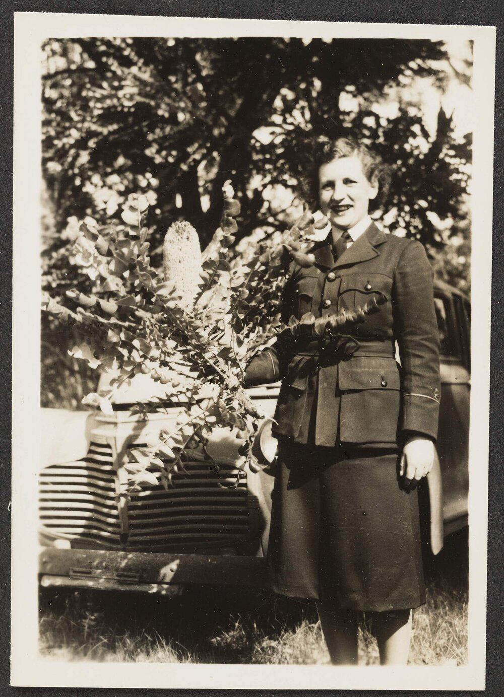 [Photograph: Margaret Blackwood [?] in WAAF uniform standing next to tree]