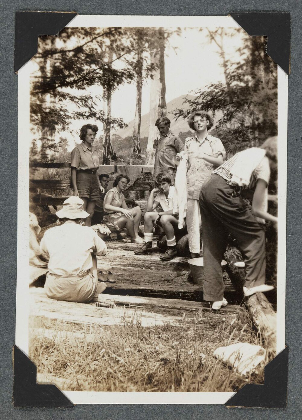 [Earnie Bond's homestead people sitting near fencing]