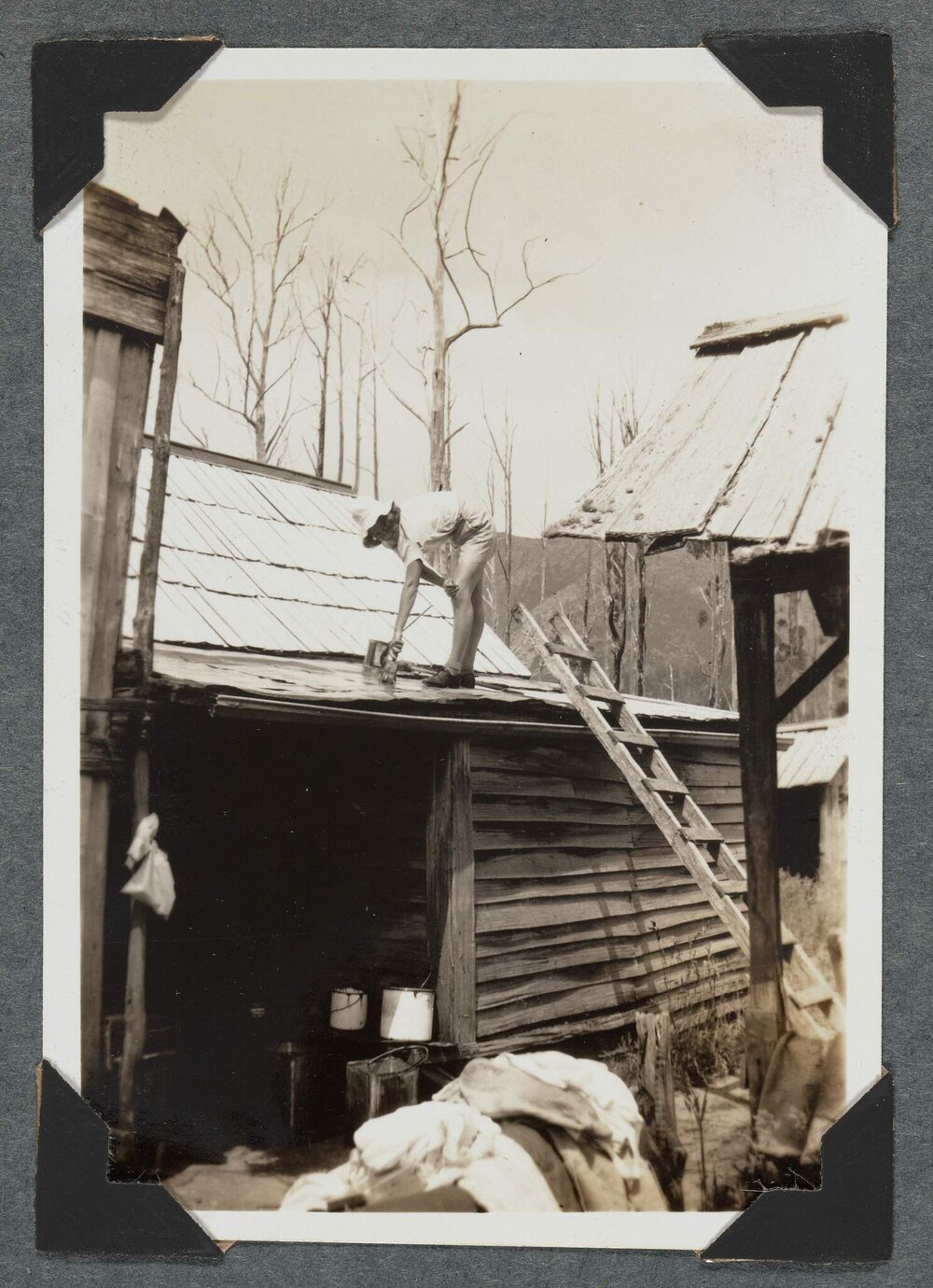 [Earnie Bond's homestead - woman up a ladder]