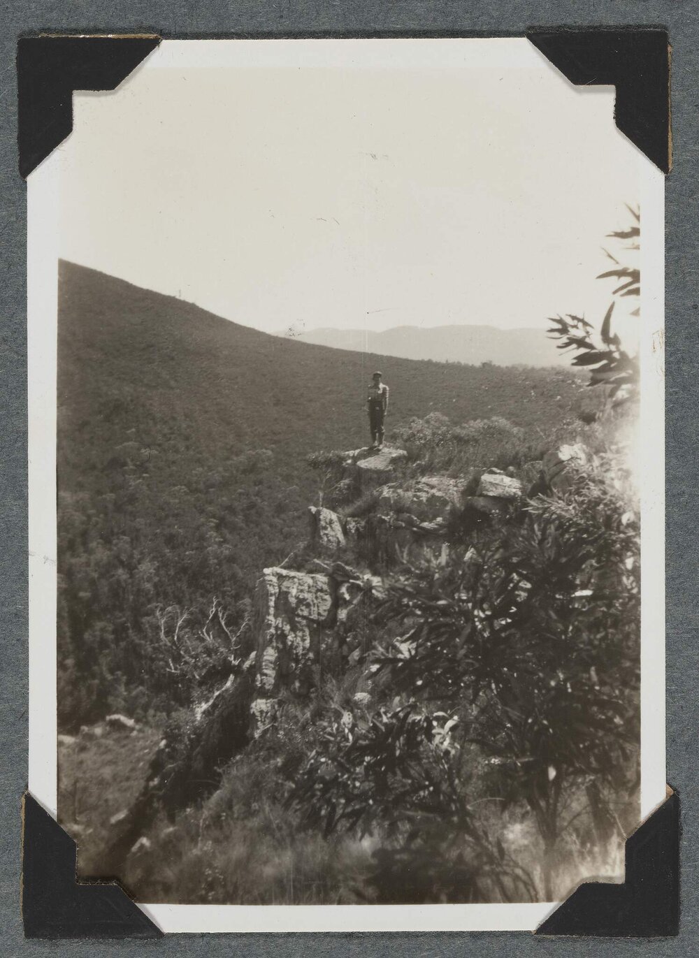 [Mountaineering Club Tasmania trip - man standing on cliff edge]