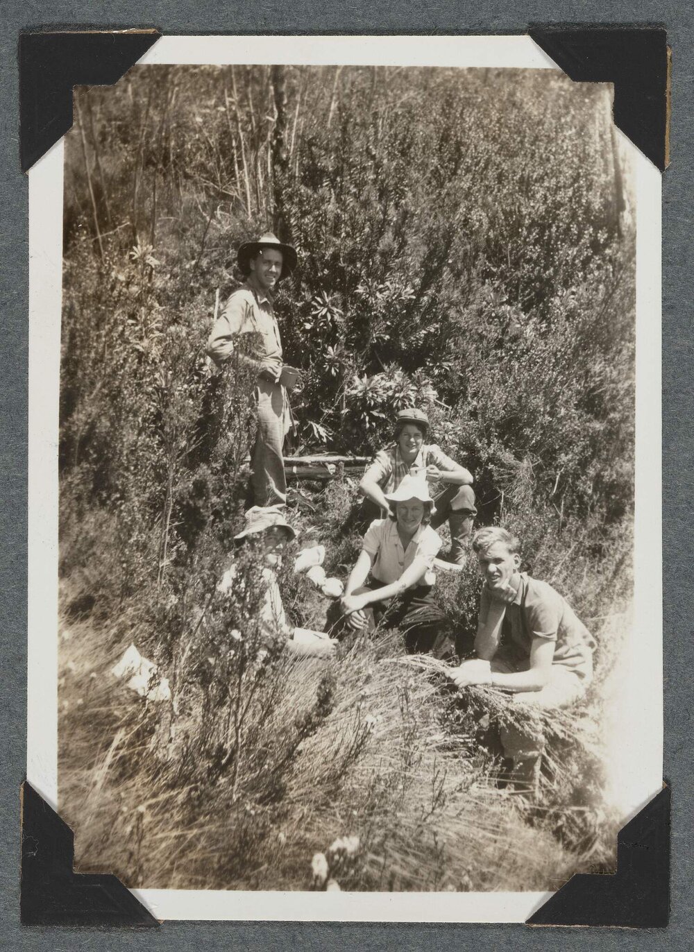 [Mountaineering Club Tasmania trip - five people seated]