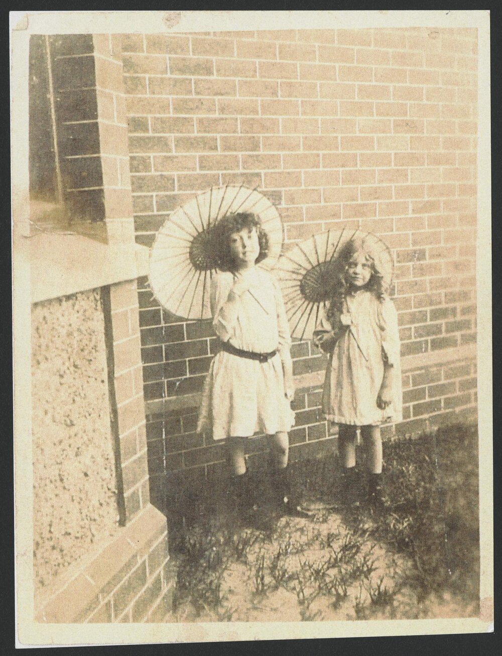 Lorna Pitt and Kathleen Pitt as children, holding parasols.