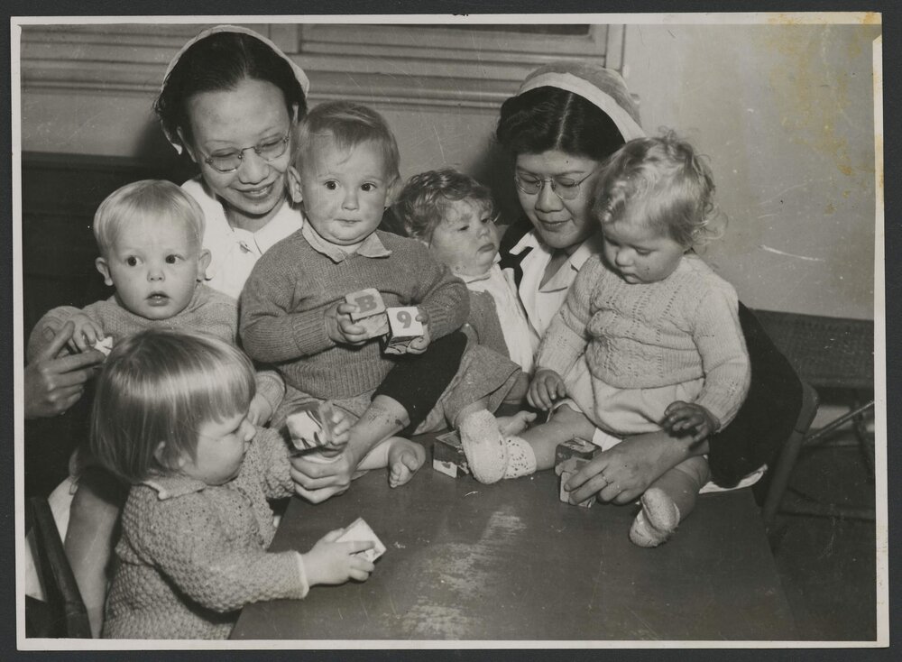 AIF Malaya Memorial Nursing Scholarship recipients with group of toddlers playing with blocks