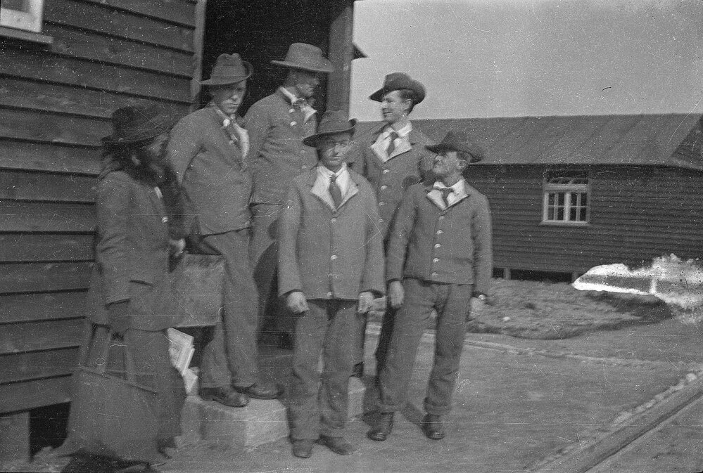 Five men and woman at the doorway