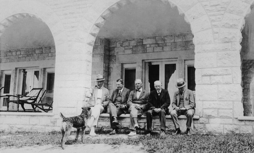 Five unidentified men and a dog