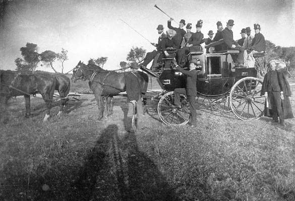 Group of people on a horse drawn carriage.