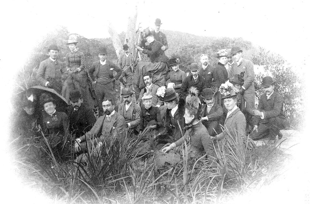 Large group, men and women, in bush setting