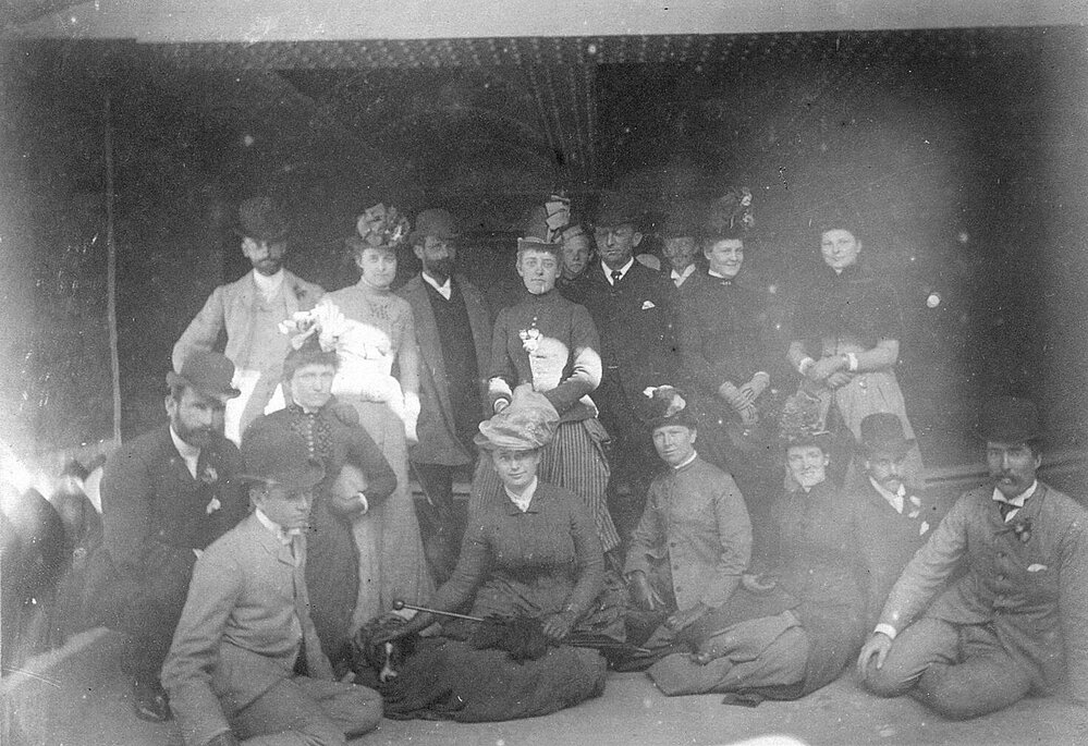 Group photo of men and women, seated and standing