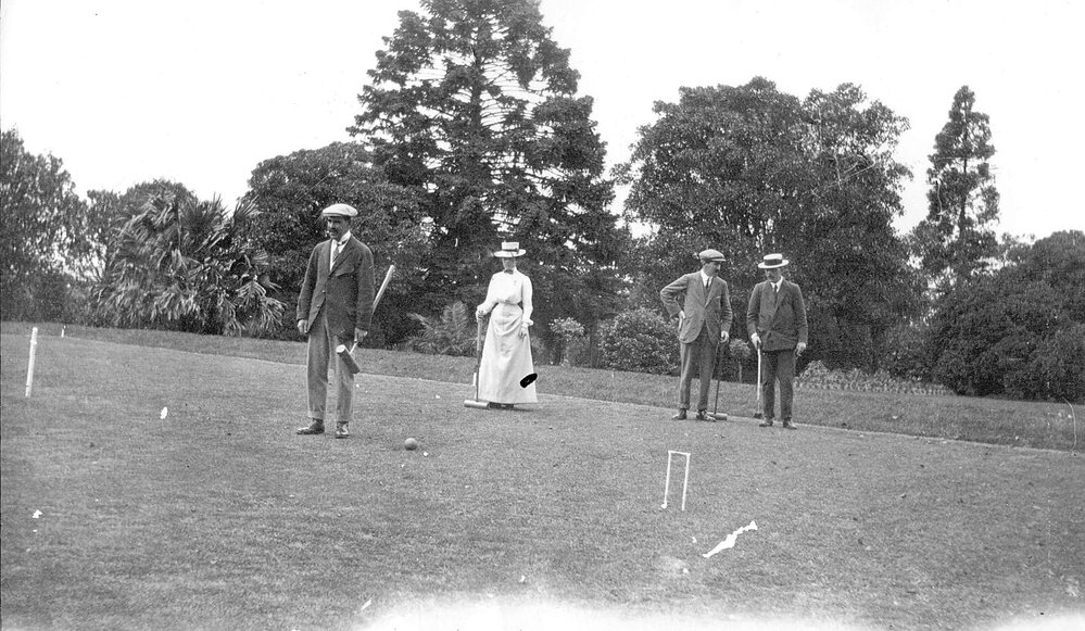 Group playing croquet
