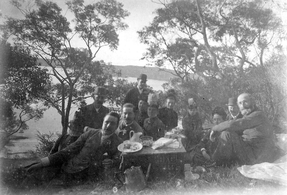 Group photo picnicking in rural setting (Purrembete)