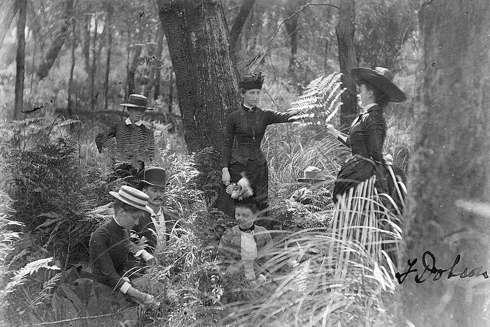 Group photo, men, women and children in bush setting