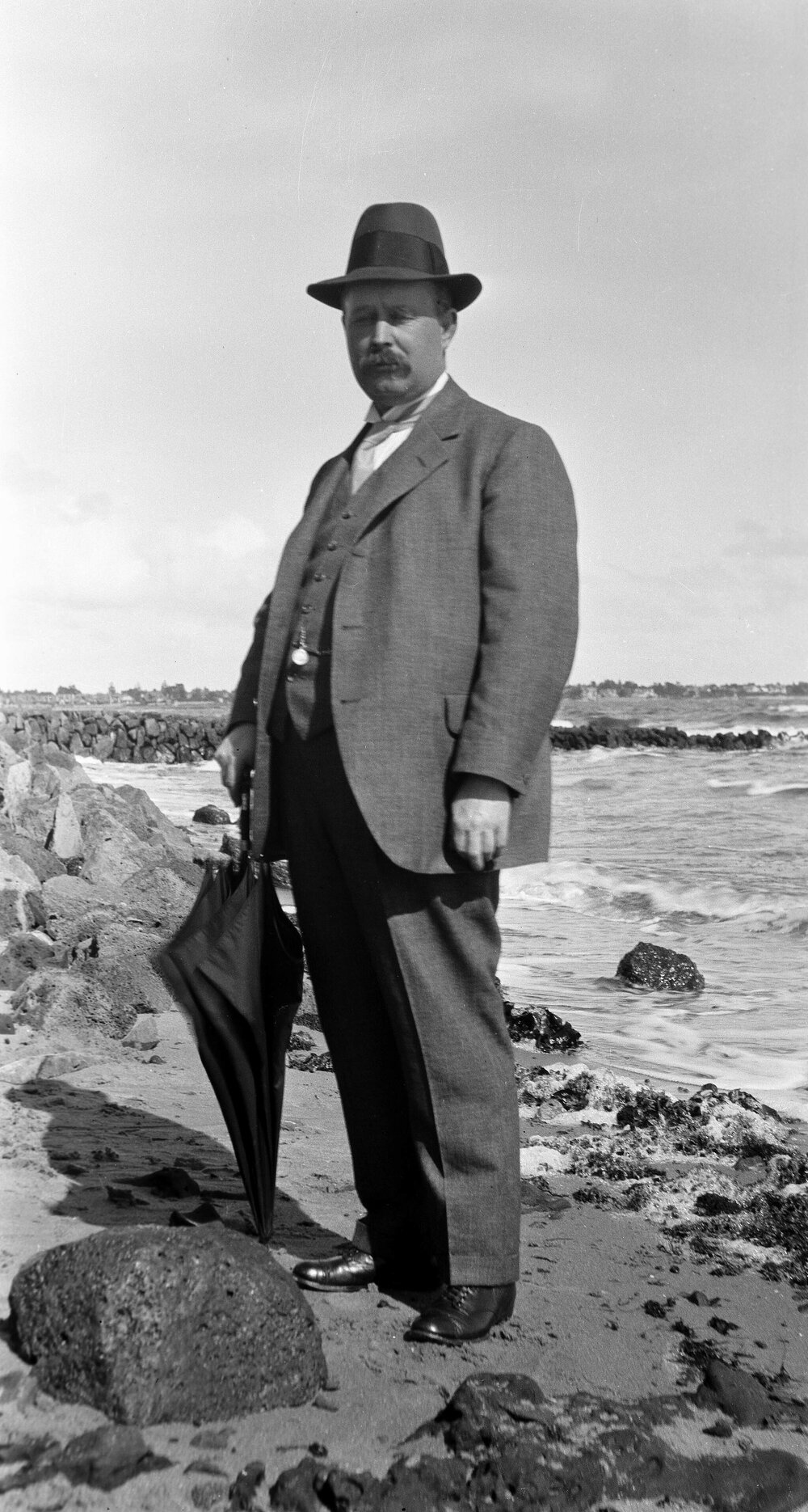 Man standing on rocky beach