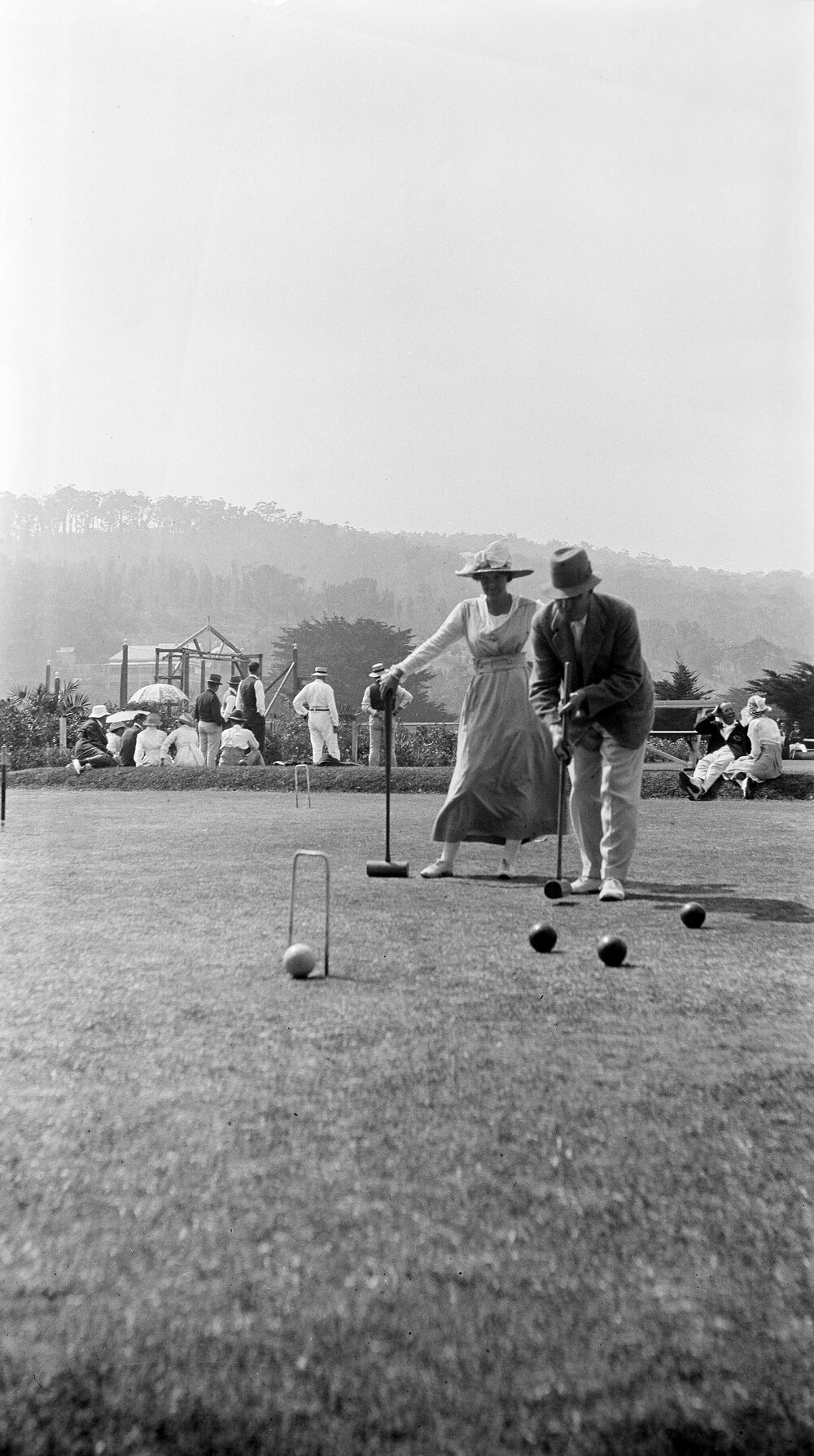 Man and a woman playing croquet at Erskine House