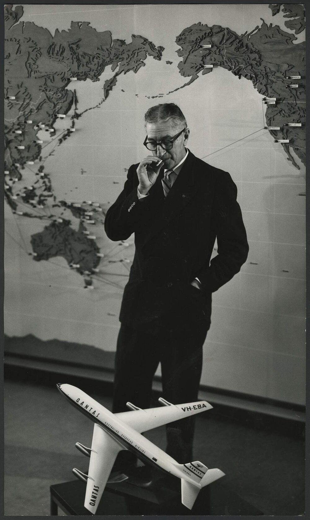 Man looking at Qantas plane model