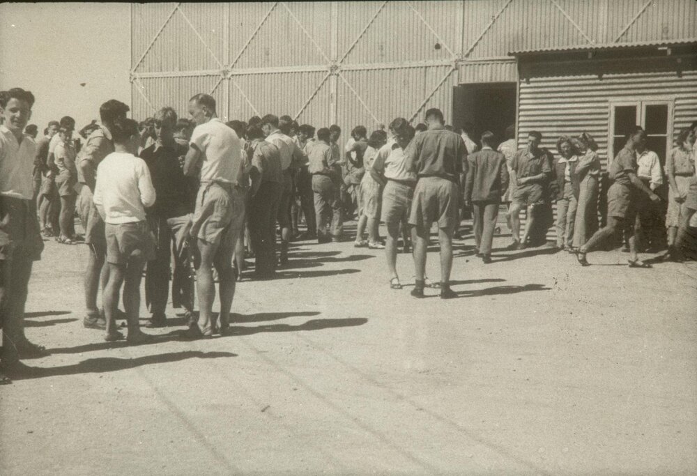Students milling outside corrogated iron classroom at Mildura branch, University of Melbourne, 1947-1949.
