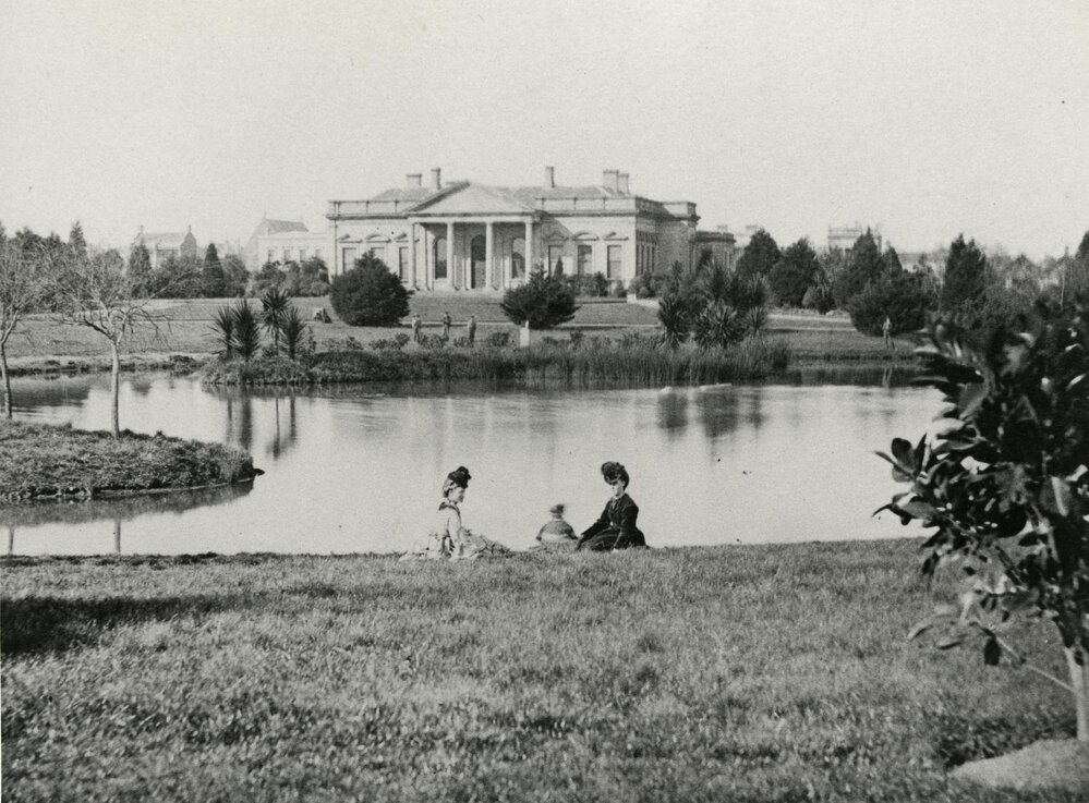 Old Medical building with lake and lawns in foreground, University of Melbourne.