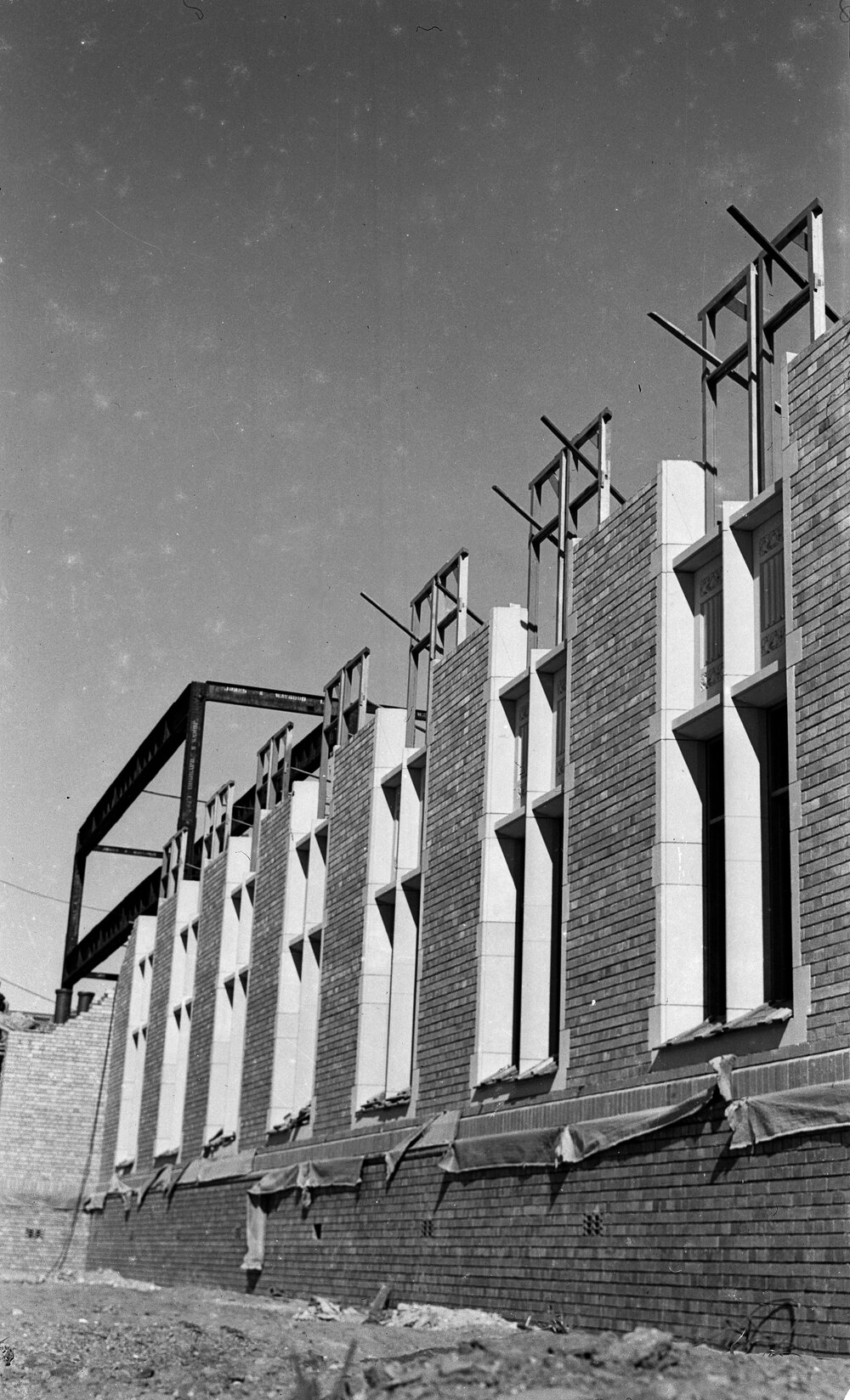 University building under construction. North face window frames.